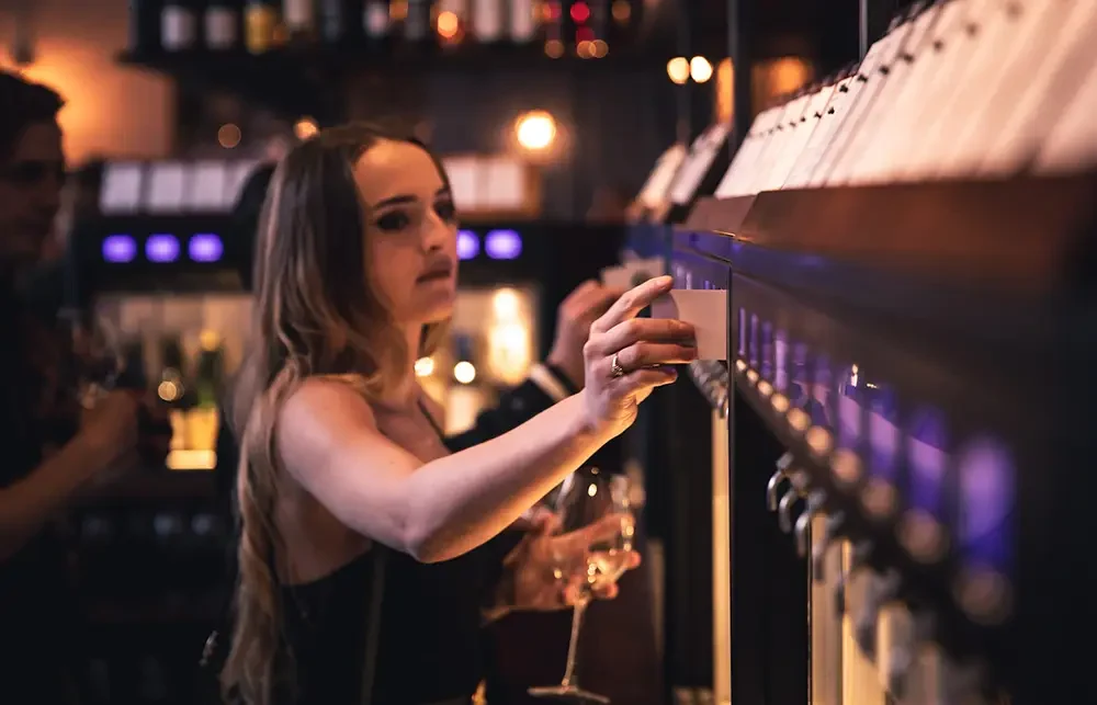 A woman pouring a glass of wine